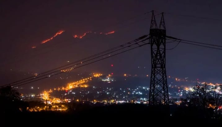 L.A. with powerline forefront, wildfire in rear