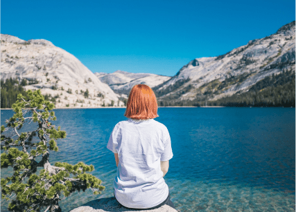 woman gazing at mountain lake